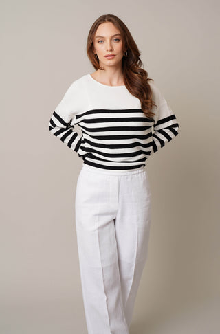 Model is wearing the striped dolman sweater by Cyrus in Bone/Black