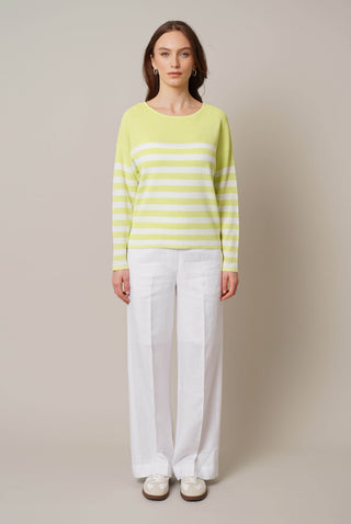 Model is wearing the striped dolman sweater by Cyrus in Celery Green/Bone