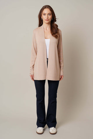 Model is wearing the open cardigan with shell button by Cyrus in Soft Camel Heather