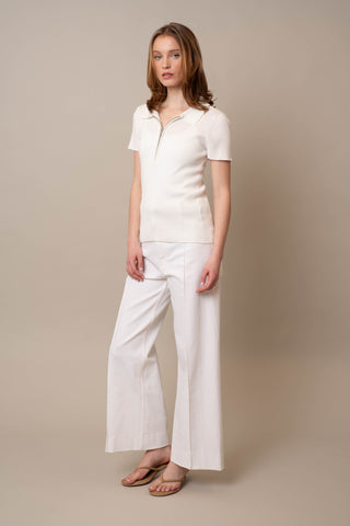 Model is wearing the Quarter Zip Short Sleeve Polo by Cyrus in Bright White