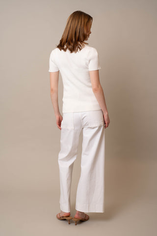 Model is wearing the Quarter Zip Short Sleeve Polo by Cyrus in Bright White