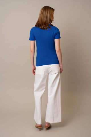 Model is wearing the Quarter Zip Short Sleeve Polo by Cyrus in Dazzling Blue