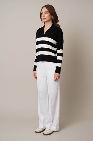 Model is wearing the striped split neck pullover by Cyrus in Black/Cream