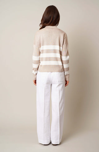 Model is wearing the striped split neck pullover by Cyrus in Oatmeal Cookie Heather/Cream