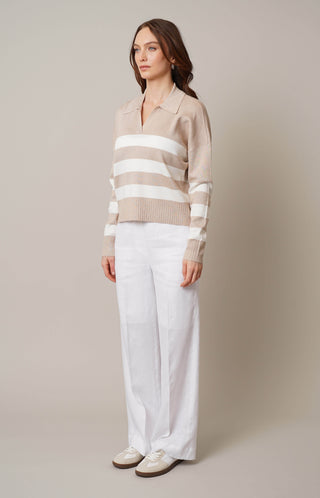 Model is wearing the striped split neck pullover by Cyrus in Oatmeal Cookie Heather/Cream