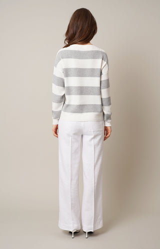 Model is wearing the striped waffle dolman by Cyrus in Light Heather Grey/Bone/Silver
