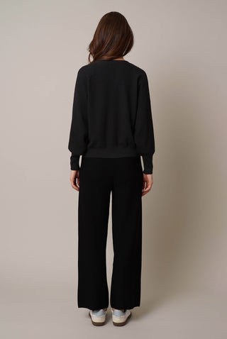 Model is wearing the loose knit pants by Cyrus in Black