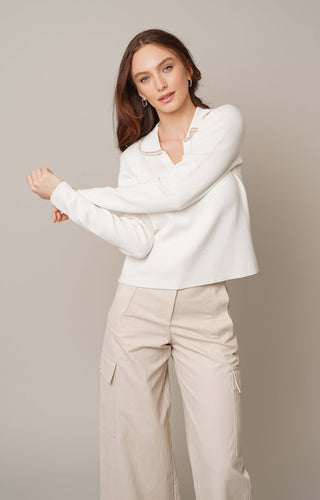 Model is wearing the long sleeve johnny collar pullover by Cyrus in Cream