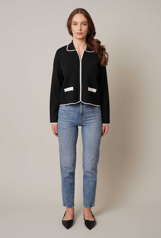 Model is wearing the zip up cardigan with tipping by Cyrus in Black/Bone