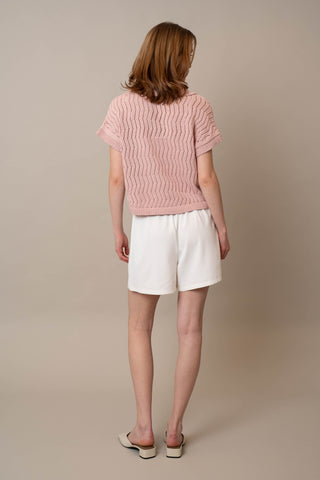 Model is wearing the Short Sleeve Dolman with Collar by Cyrus in Soft Blush