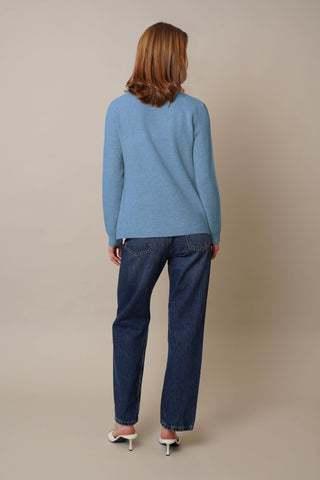 Model is wearing the Waffle Cardigan with Pockets by Cyrus in Sheltering Blue