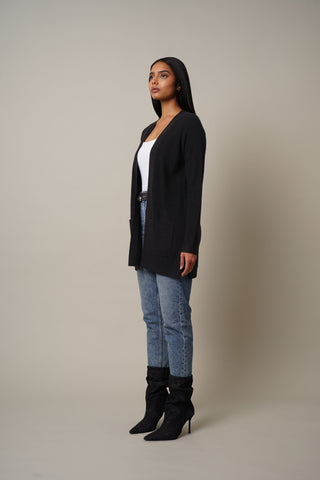 Model is wearing the Waffled Cardigan with Pockets in Black.