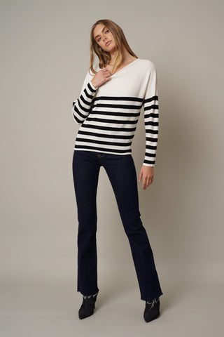 model wearing the Waffled Striped Dolman Sweater by cyrus in cream/black