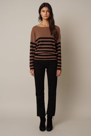 model wearing the Waffled Striped Dolman Sweater by cyrus in brown/black