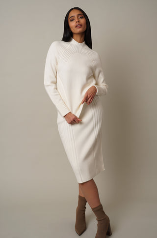 Model is wearing the Mock Neck Pullover with Ribs in Cream.
