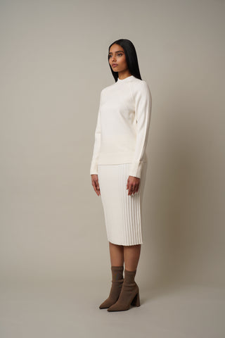 Model is wearing the Mock Neck Pullover with Ribs in Cream.