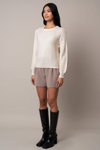 Model is wearing the wide-sleeve-cable-pullover in Cream