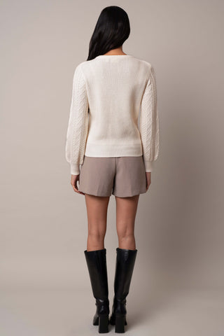 Model is wearing the wide-sleeve-cable-pullover in Cream