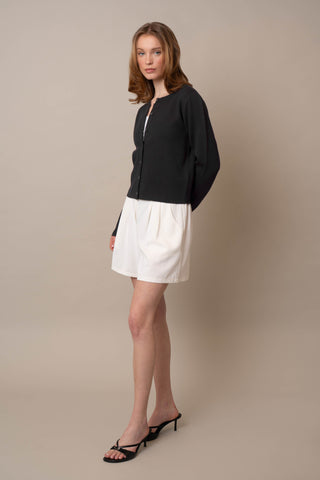 Model is wearing the Crew Neck Button Down Cardigan by Cyrus in Black