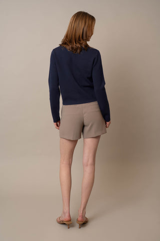 Model is wearing the Crew Neck Button Down Cardigan by Cyrus in Eclipse