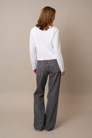 Model is wearing the Crew Neck Button Down Cardigan by Cyrus in White