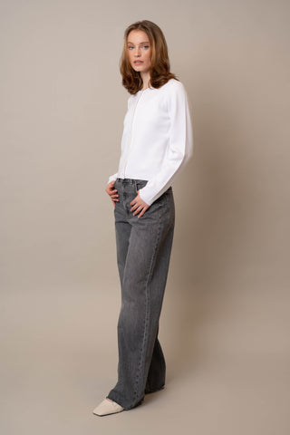 Model is wearing the Crew Neck Button Down Cardigan by Cyrus in White