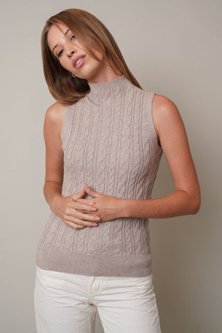 Model is wearing the Mock Neck Cable Knit Tankby Cyrus in Kitten Heather