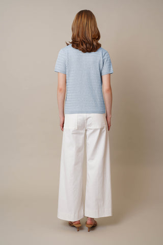 Model is wearing the Novelty Short Sleeve Pullover by Cyrus in Ice Sky