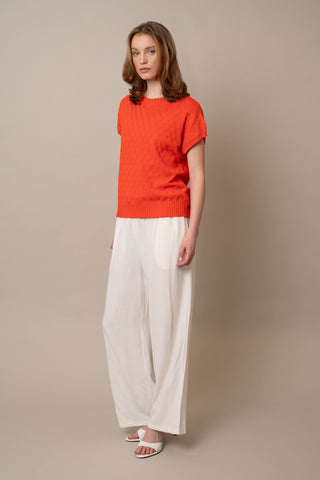 Model is wearing the Cable Crew Neck Pullover by Cyrus in Tangerine Tango