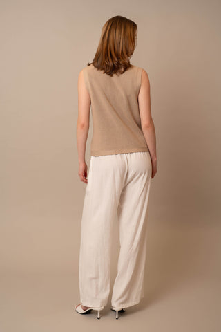 Model is wearing the Button Front V-Neck Vest by Cyrus in Irish Cream