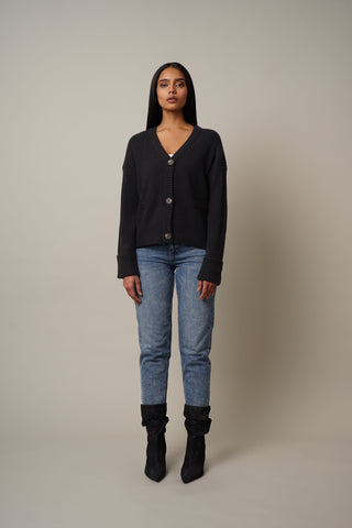 Model is wearing the V-Neck Button Down Cardigan in Black.
