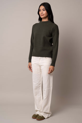 Model is wearing the mock-neck-pointelle-sweater in Waxed Loden