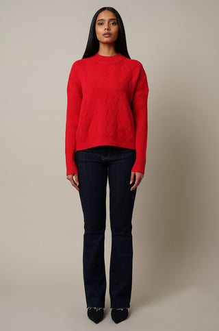 Model is wearing the Mock Neck Cable Knit Pullover in Cabernet Red.