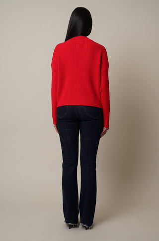Model is wearing the Mock Neck Cable Knit Pullover in Cabernet Red.