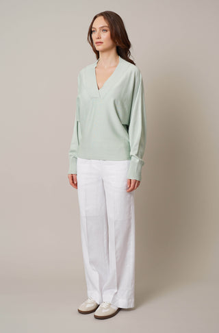 Model is wearing the v neck dolman sweater by Cyrus in Silt Green