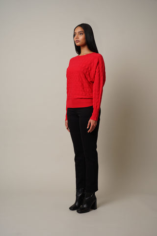 Model is wearing the Cable Knit Dolman Pullover in Cabernet Red.