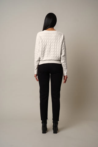 Model is wearing the Cable Knit Dolman Pullover in Cream.