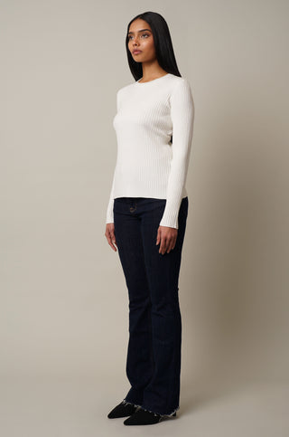 Model is wearing the Crew Neck Ribbed Pullover in Cream.