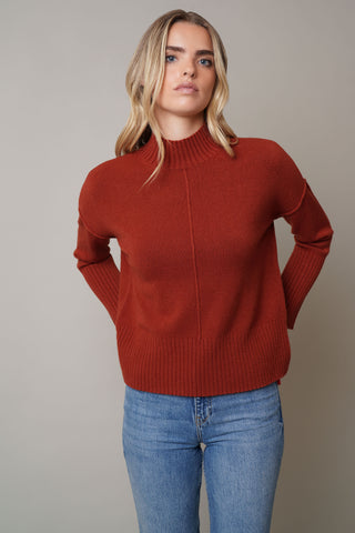 Model is wearing the Mock Neck Pullover Sweaterby Cyrus in Colorado