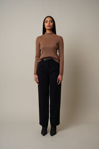 Model is wearing the Ribbed Funnel Neck Pullover in Tobacco Brown.