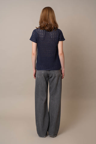 Model is wearing the Short Sleeve Crochet Polo by Cyrus in Eclipse