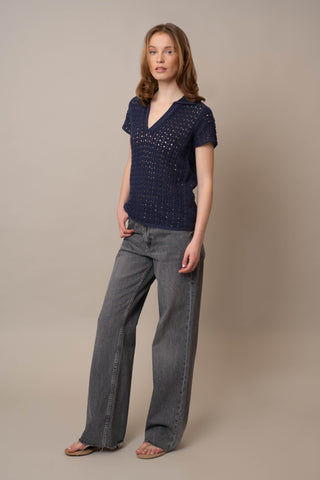 Model is wearing the Short Sleeve Crochet Polo by Cyrus in Eclipse