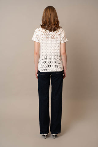 Model is wearing the Short Sleeve Crochet Polo by Cyrus in Bone