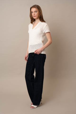Model is wearing the Short Sleeve Crochet Polo by Cyrus in Bone