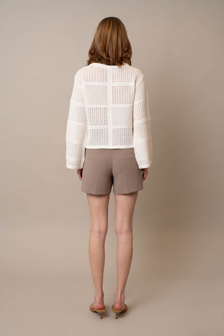 Model is wearing the Novelty Crochet Pullover by Cyrus in Bone