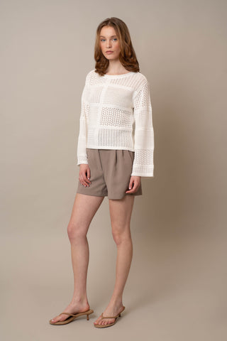 Model is wearing the Novelty Crochet Pullover by Cyrus in Bone
