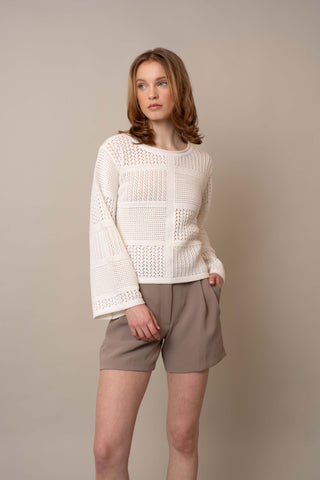 Model is wearing the Novelty Crochet Pullover by Cyrus in Bone