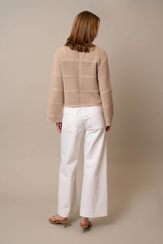 Model is wearing the Novelty Crochet Pullover by Cyrus in Oatmeal Cookie Heather