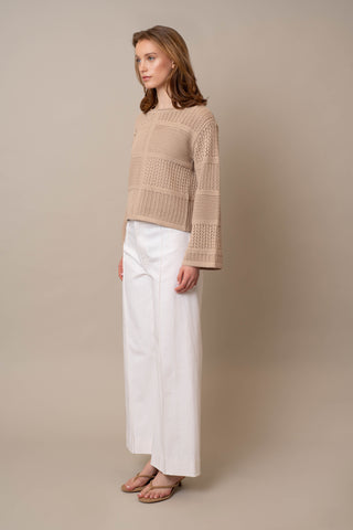 Model is wearing the Novelty Crochet Pullover by Cyrus in Oatmeal Cookie Heather