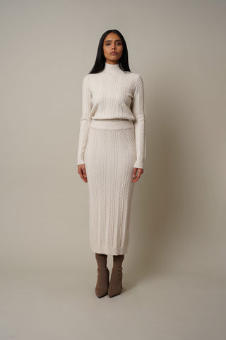 Model is wearing the Cable Knit Skirt in Cream.